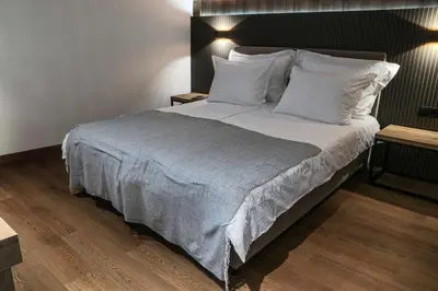 a bedroom with a large bed with white sheets and pillows at Best Western Plus Lozenetz Hotel in Sofia
