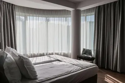 a bedroom with a bed and a large window at Best Western Plus Lozenetz Hotel in Sofia