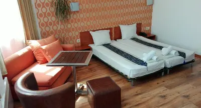 a living room with a bed and a couch at Scotty's Boutique Hotel in Sofia