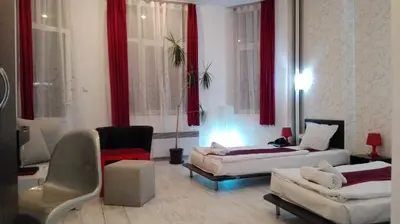 a living room with two beds and red curtains at Scotty's Boutique Hotel in Sofia