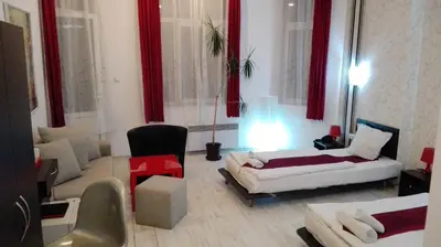 a large living room with red curtains and a couch at Scotty's Boutique Hotel in Sofia