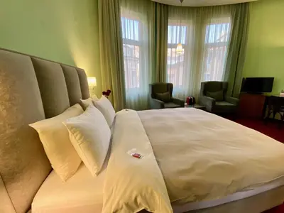 a hotel room with a large bed with white pillows at Art 'Otel in Sofia