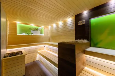 a sauna with a large screen tv in it at Spa Hotel Ezeretz Blagoevgrad in Blagoevgrad
