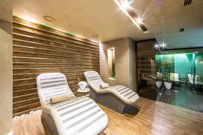 a spa room with two chairs and a tub at Spa Hotel Ezeretz Blagoevgrad in Blagoevgrad