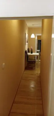 a hallway leading to a room with a table at Benita Inn apartments in Sofia