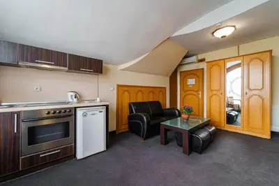 a kitchen with a couch and a table in a room at Hotel Avion - Self check in in Plovdiv