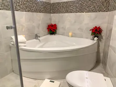 a bathroom with a bath tub and a toilet at Atlantic Hotel - Free Parking in Sofia