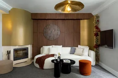 a bedroom with a white bed and a fireplace at Oborishte 63,The Art Boutique Hotel by Sandglass in Sofia