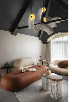 a living room with a large brown rug and a table at Oborishte 63,The Art Boutique Hotel by Sandglass in Sofia