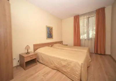 a bedroom with a large bed and a window at Hotel Gloria Palace Diplomat in Sofia