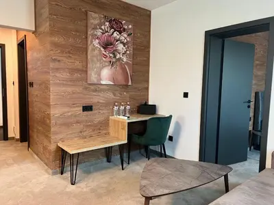 a room with a wooden wall with a table and chairs at Perun Hotel Sandanski in Sandanski
