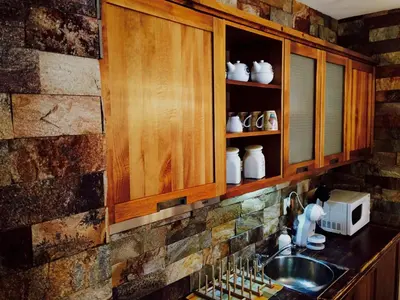 a kitchen with wooden cabinets and a sink at St. John Hill Bansko in Bansko