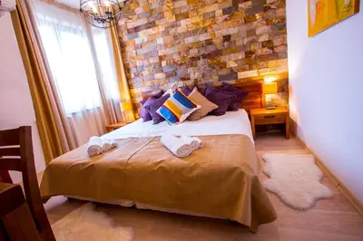a bedroom with a bed and a brick wall at St. John Hill Bansko in Bansko