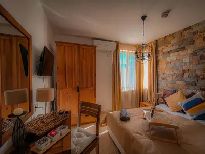 a bedroom with a bed and a brick wall at St. John Hill Bansko in Bansko