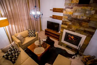 a living room with a couch and a fireplace at St. John Hill Bansko in Bansko