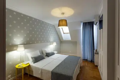 a bedroom with a bed and a wall with stars at Dunav Apartment House in Sofia