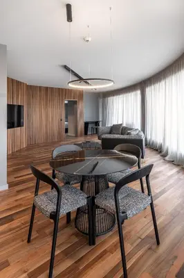 a living room with a table and chairs and a couch at Hotel VEGA Sofia in Sofia