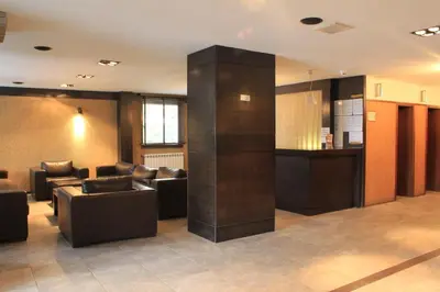 a lobby with couches and a pillar in a building at Fortuna Luxury Apartment in Bansko