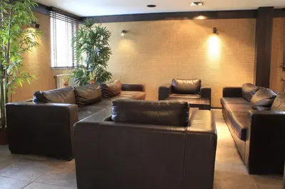 a waiting room with leather couches and plants at Fortuna Luxury Apartment in Bansko