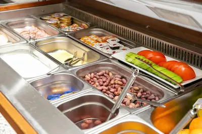 a refrigerator filled with different types of food at Hotel Niky in Sofia
