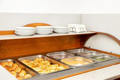 a kitchen sink with a tray of pastries and plates at Hotel Niky in Sofia