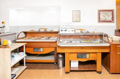 a kitchen with two sets of dishes on display at Hotel Niky in Sofia