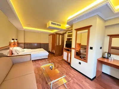 a hotel room with a bed and a couch at California Hotel in Sofia