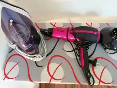 a pink hairdryer sitting on top of a table at Central Academic Apartment Sofia in Sofia