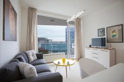 a living room with a couch and a table at Michelle Apartment in Sofia