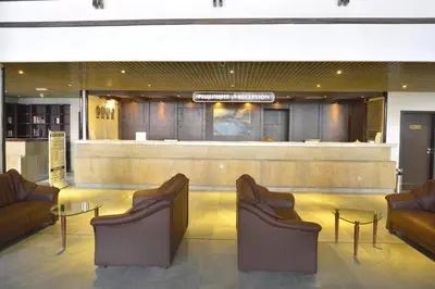 a lobby with chairs and a table and a bar at Hotel Samokov in Borovets