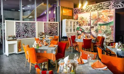 a restaurant with tables and chairs in a room at Alliance Hotel in Plovdiv