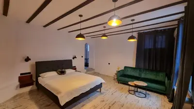 a bedroom with a bed and a green couch at My Guest Rooms in Plovdiv