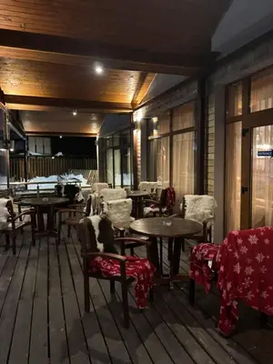 a room with tables and chairs and tablesearcher at The Lodge Hotel in Borovets