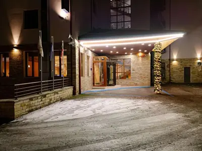 a building with a pole in the snow at night at The Lodge Hotel in Borovets