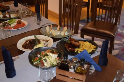 a table with plates of food on top at The Lodge Hotel in Borovets