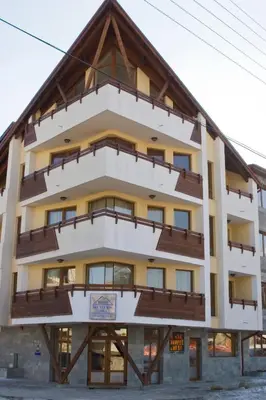a large building with a wooden roof at Mountview Lodge Apartments in Bansko