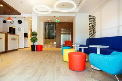 a lobby with colorful chairs and tables at Best Western Terminus Hotel in Sofia