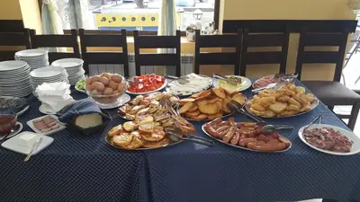 a blue table with plates of food on it at Hotel Via Trayana in Beli Osŭm