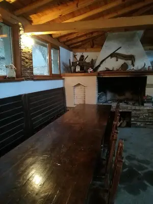 a large wooden table in a room with a fireplace at Tree House in Sofia