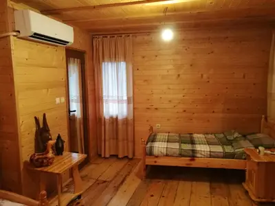 a bedroom with a bed and a wooden wall at Tree House in Sofia