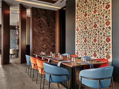 a restaurant with a long table and chairs at Crowne Plaza Sofia by IHG in Sofia