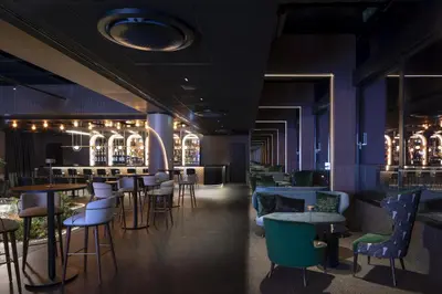 a restaurant with blue walls and tables and chairs at Crowne Plaza Sofia by IHG in Sofia