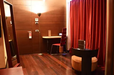 a room with a table and a red curtain at Les Fleurs Boutique Hotel in Sofia