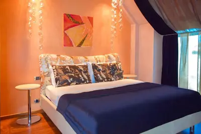 a bedroom with a bed with a chandelier above it at Les Fleurs Boutique Hotel in Sofia