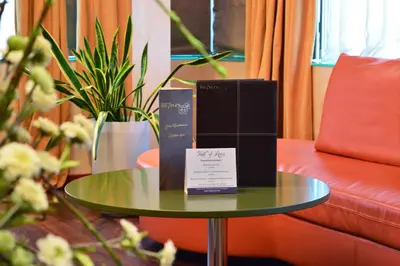 a table with boxes on it next to a couch at Les Fleurs Boutique Hotel in Sofia