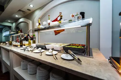 a buffet line with plates of food and drinks at MPM Hotel Guinness in Bansko