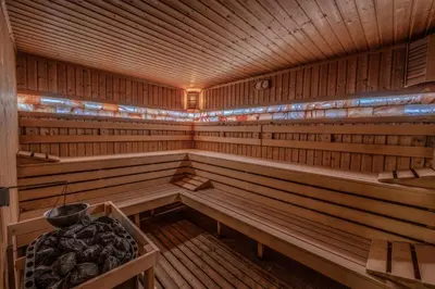 a large wooden sauna with wooden benches in it at MPM Hotel Guinness in Bansko