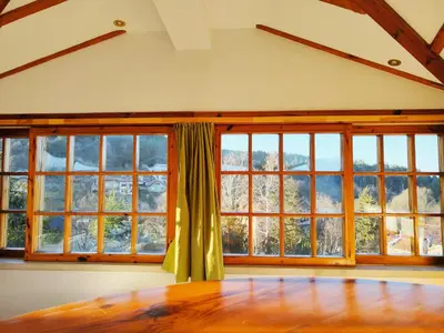 a room with large windows and a wooden table at Park Hotel Amfora -Free Parking in Sofia