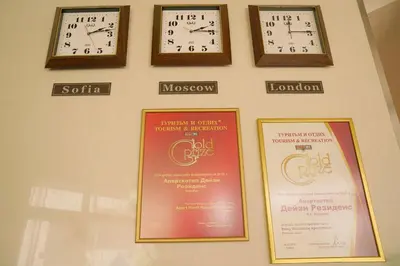 a wall with three clocks on a wall at Apart Hotel Flora Residence Daisy in Borovets