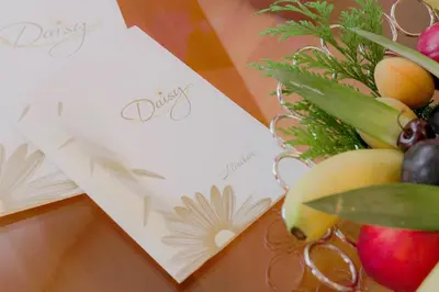 a bunch of fruit and vegetables on a table with cards at Apart Hotel Flora Residence Daisy in Borovets